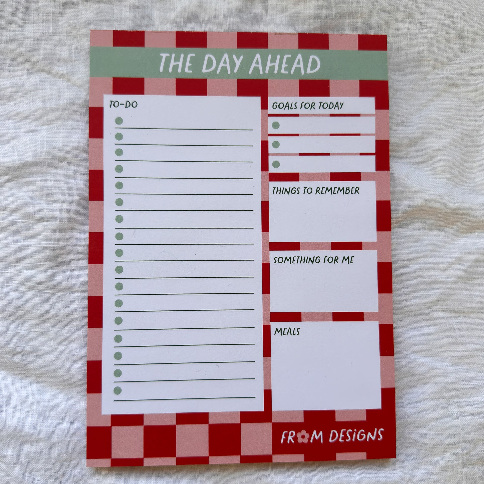 Notepad with a checkered border and text sections on a white background
